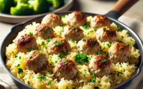 Turkey Meatballs with Lemony Rice served in a skillet with garnished parsley and lemon wedges